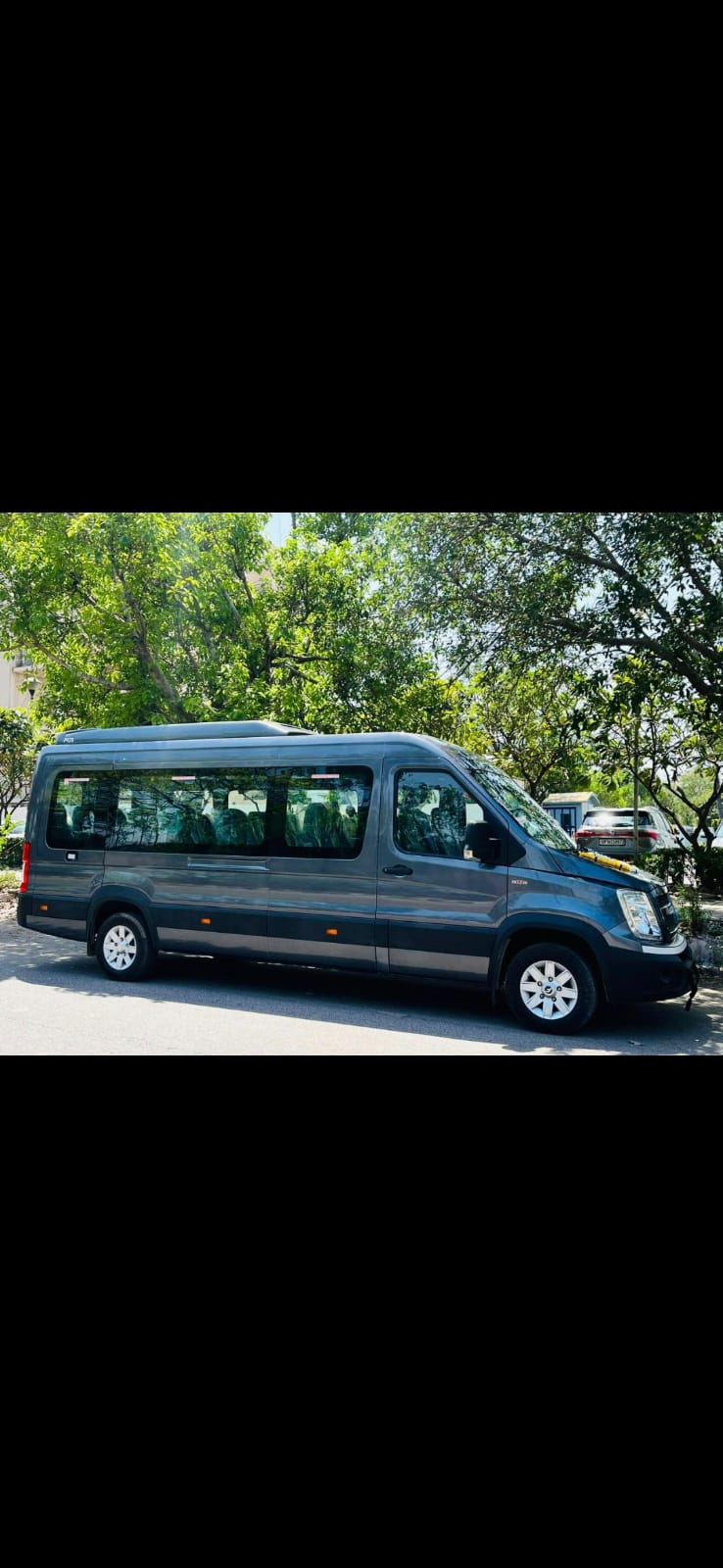 Luxury van interior with premium beige leather captain seats - Outstation tour vehicle Delhi
